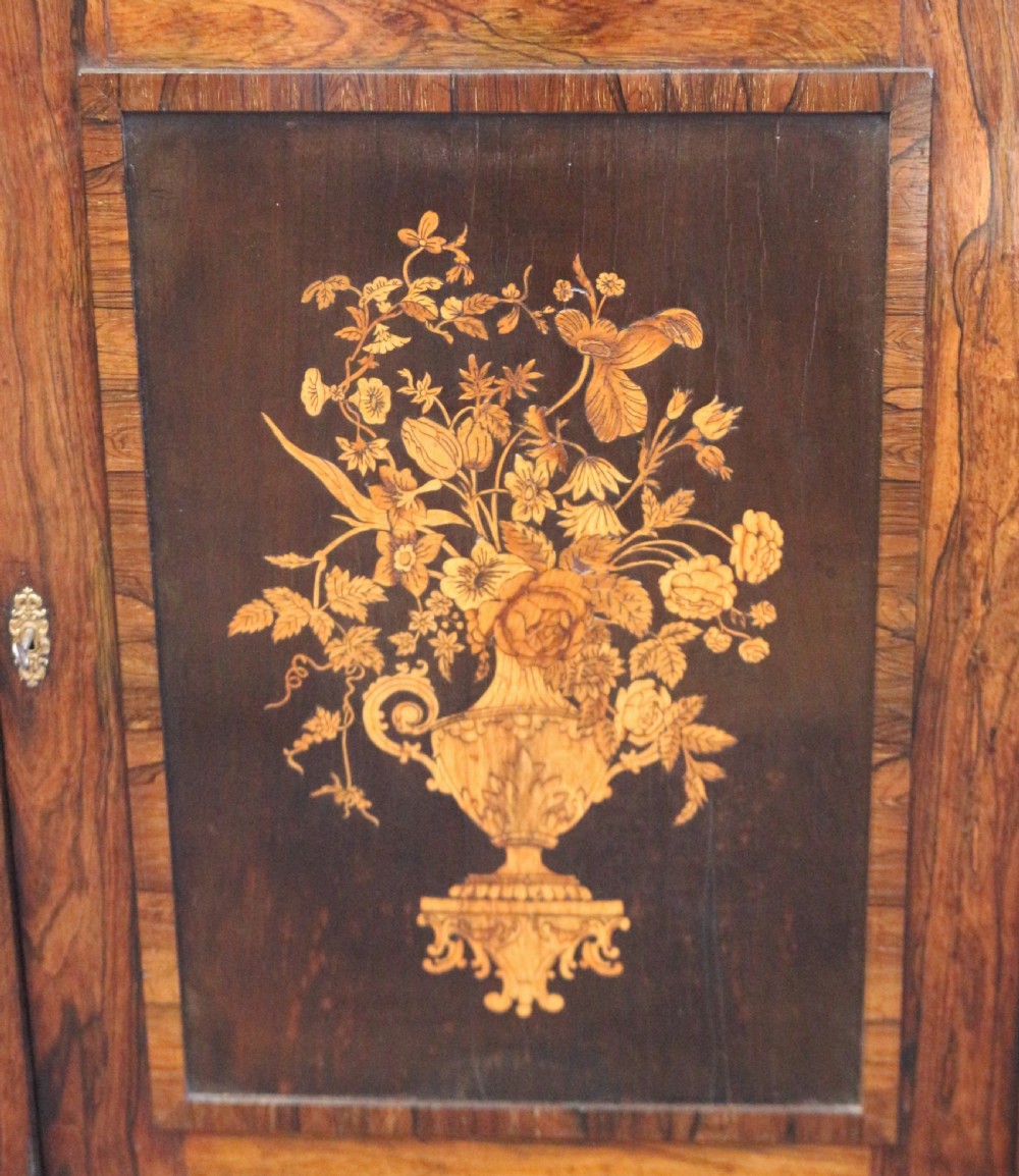 A Victorian rosewood side cupboard featuring an inlaid floral marquetry central door, flanking inlaid side panels, and a grey marble top. View VIII