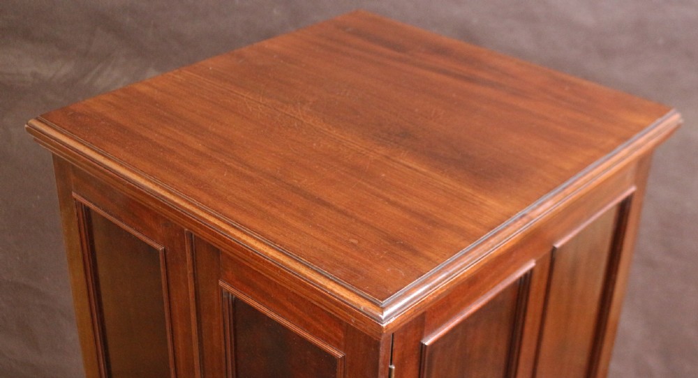 An Edwardian mahogany safe cabinet featuring twin upper panelled doors over three drawers with brass drop handles on a plinth base. View VII