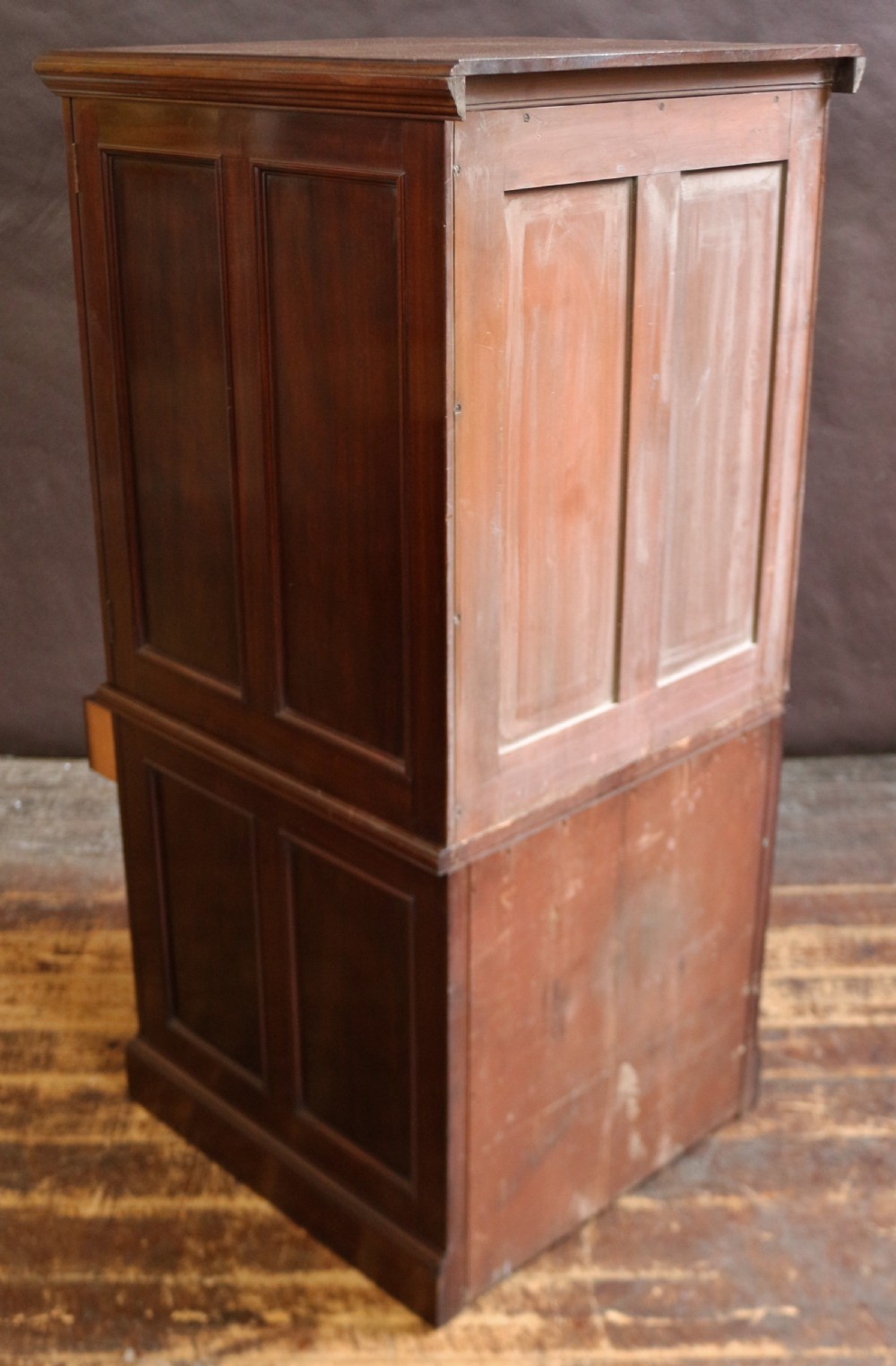 An Edwardian mahogany safe cabinet featuring twin upper panelled doors over three drawers with brass drop handles on a plinth base. View XVI
