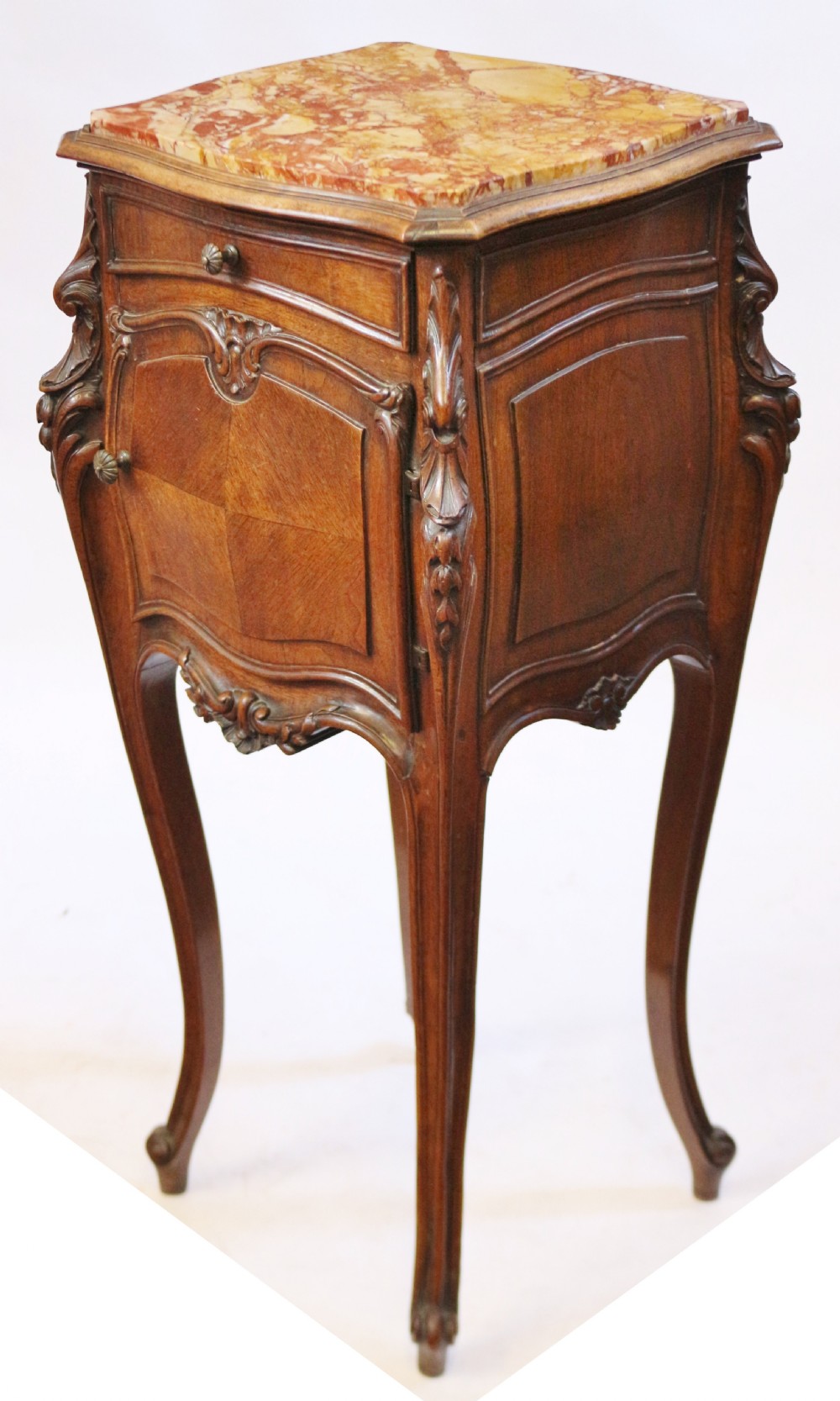 A 19th-century French walnut bedside cupboard featuring an inset variegated marble top, a top drawer, a quarter-veneered cupboard door, ornate rocaille carvings, and slender cabriole legs. View III