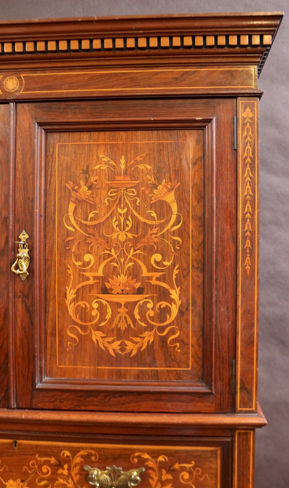 An Edwardian rosewood cupboard on chest featuring elaborate floral satinwood marquetry inlay, a two-door upper section, and five lower drawers with brass handles. View VII