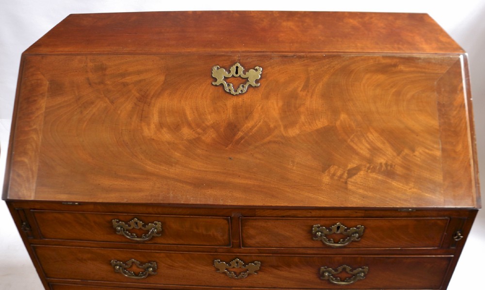 An 18th-century George III mahogany bureau with a slant-front writing slope, five graduated drawers, brass swan-neck handles, and bracket feet. View III