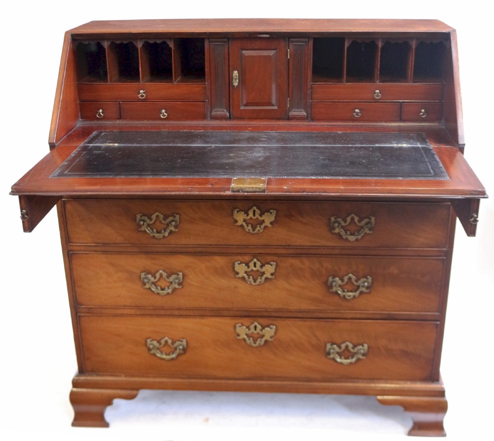 An 18th-century George III mahogany bureau with a slant-front writing slope, five graduated drawers, brass swan-neck handles, and bracket feet. View IV
