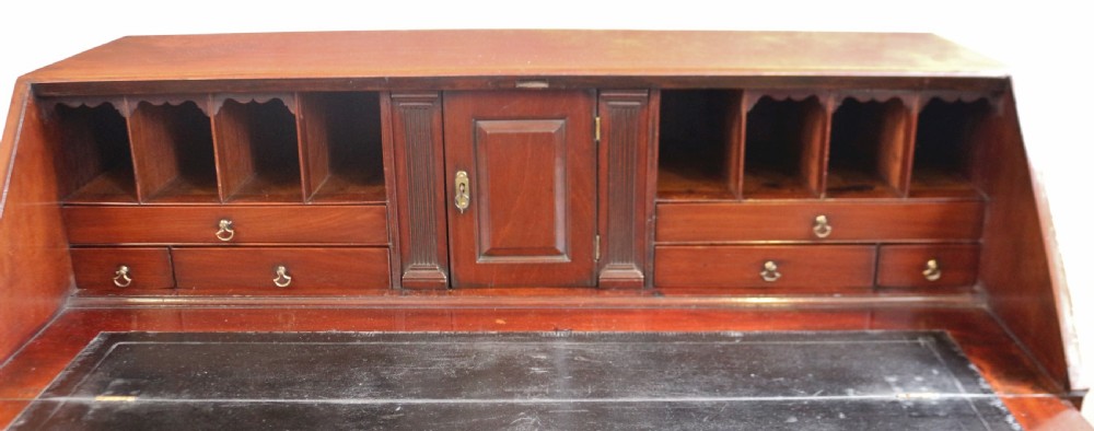 An 18th-century George III mahogany bureau with a slant-front writing slope, five graduated drawers, brass swan-neck handles, and bracket feet. View VI