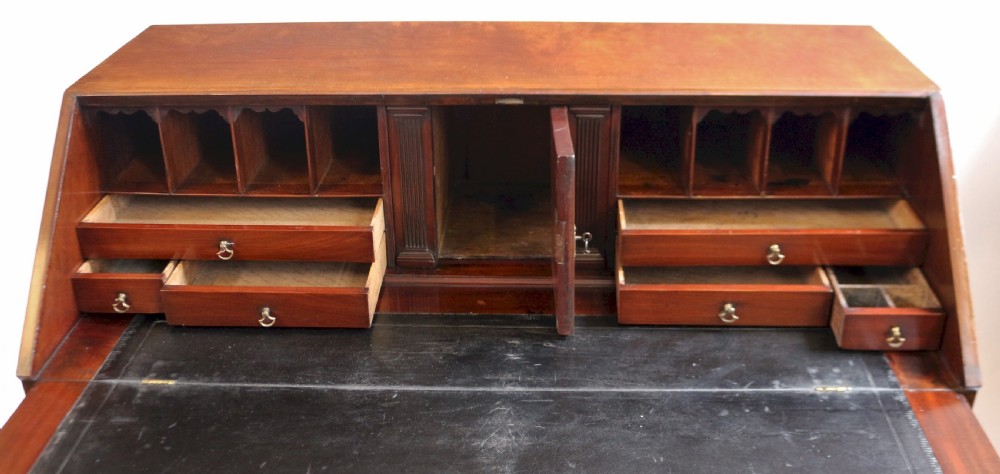 An 18th-century George III mahogany bureau with a slant-front writing slope, five graduated drawers, brass swan-neck handles, and bracket feet. View VIII