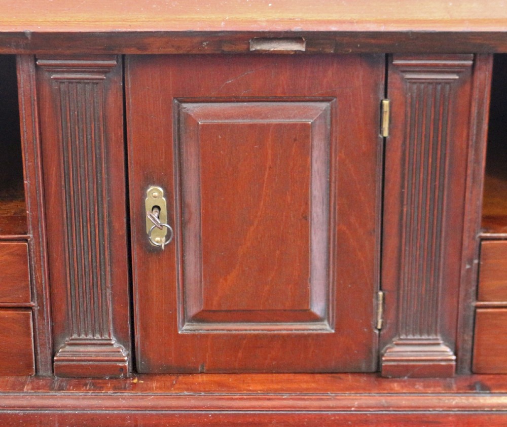An 18th-century George III mahogany bureau with a slant-front writing slope, five graduated drawers, brass swan-neck handles, and bracket feet. View IX