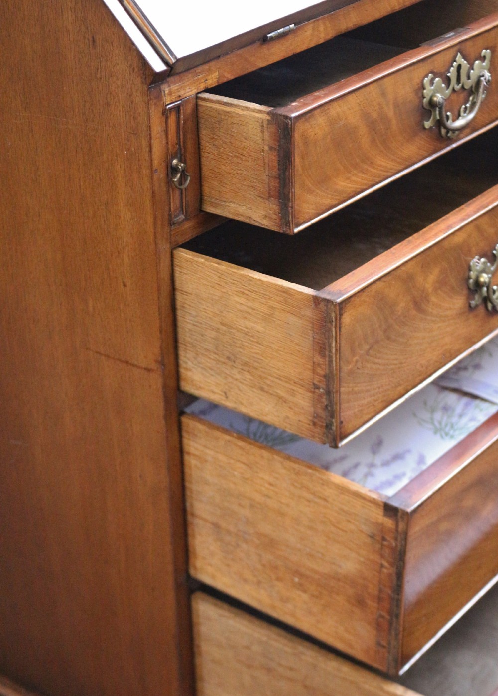 An 18th-century George III mahogany bureau with a slant-front writing slope, five graduated drawers, brass swan-neck handles, and bracket feet. View XI