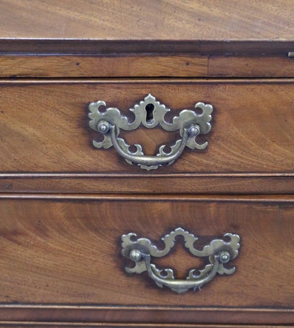 An 18th-century George III mahogany bureau with a slant-front writing slope, five graduated drawers, brass swan-neck handles, and bracket feet. View XII