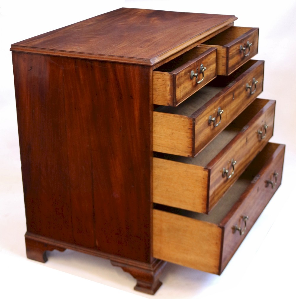 An antique Georgian mahogany chest of drawers featuring a two-over-three drawer configuration with brass swan-neck handles and shaped ogee bracket feet. View II