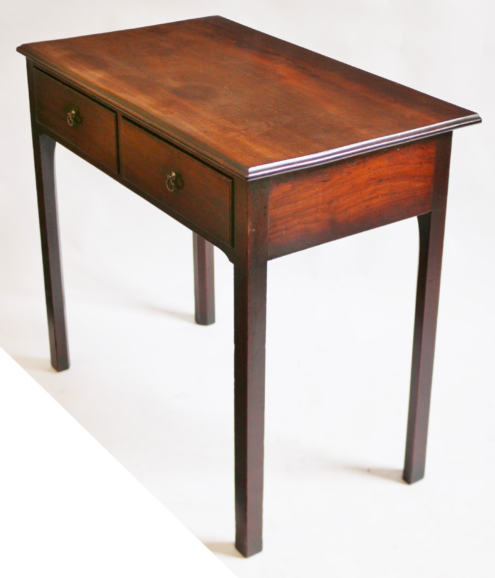 A George III mahogany side table featuring a flat rectangular top above two frieze drawers with brass handles, raised on four straight legs. View V