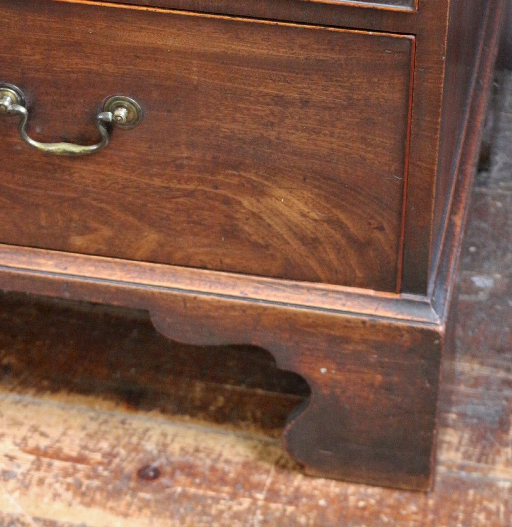 A George III mahogany chest on chest featuring two short over five long graduated drawers with brass swan-neck handles on bracket feet. View VIII