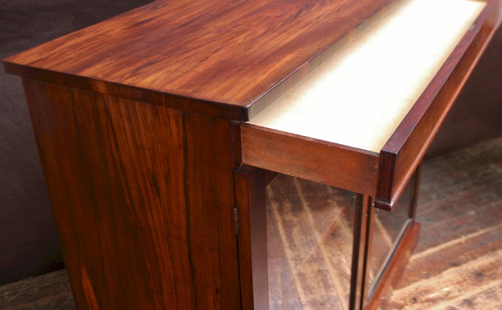 A George IV thuya wood side cabinet featuring two glazed doors, internal shelves, and a solid plinth base. View VI