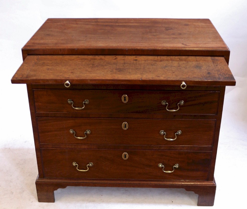 A Georgian mahogany chest of drawers featuring four graduated long drawers with brass swan-neck handles, a pull-out brushing slide, and classic bracket feet. View III