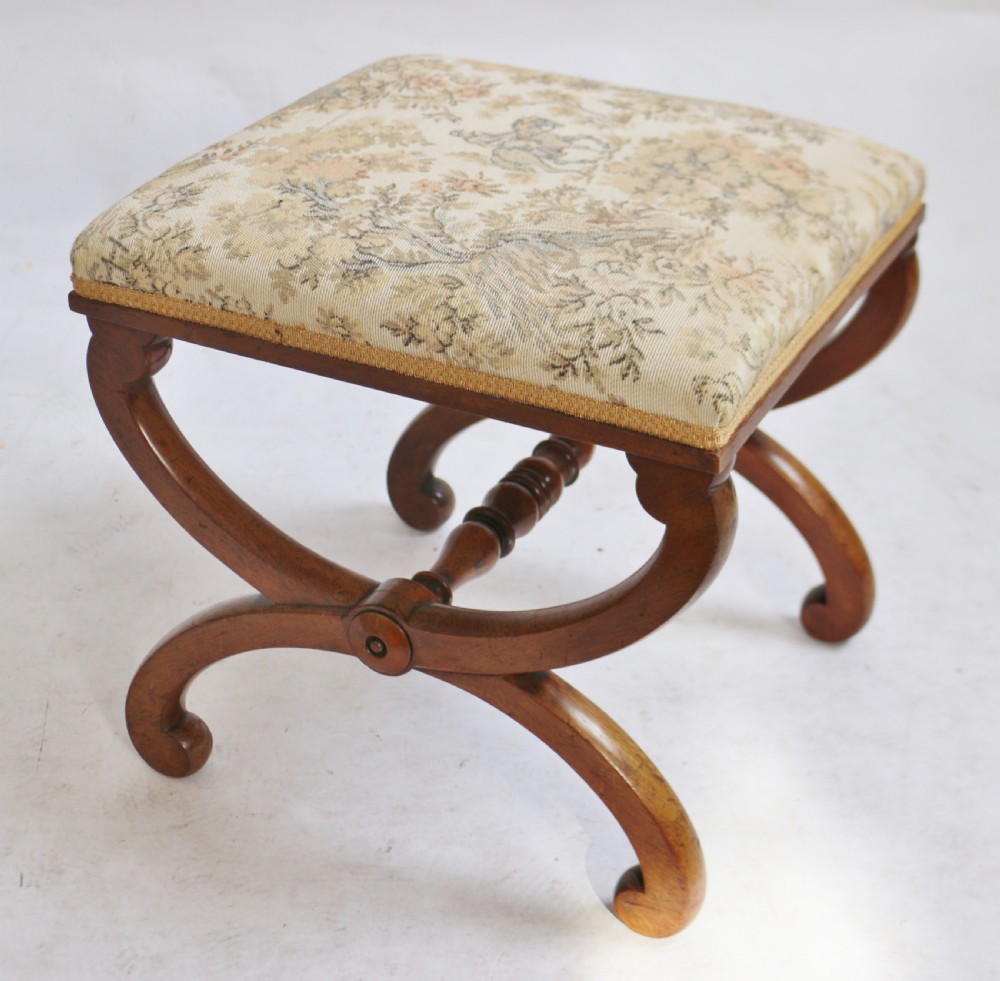 Victorian mahogany X-frame dressing stool featuring curved legs, a turned central stretcher, and a cream upholstered patterned seat. View IV