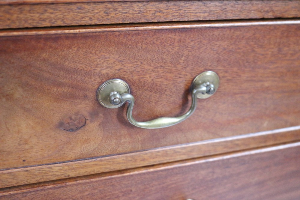 A George III mahogany four-drawer chest featuring brass swan-neck handles, keyhole escutcheons, and bracket feet. View VI