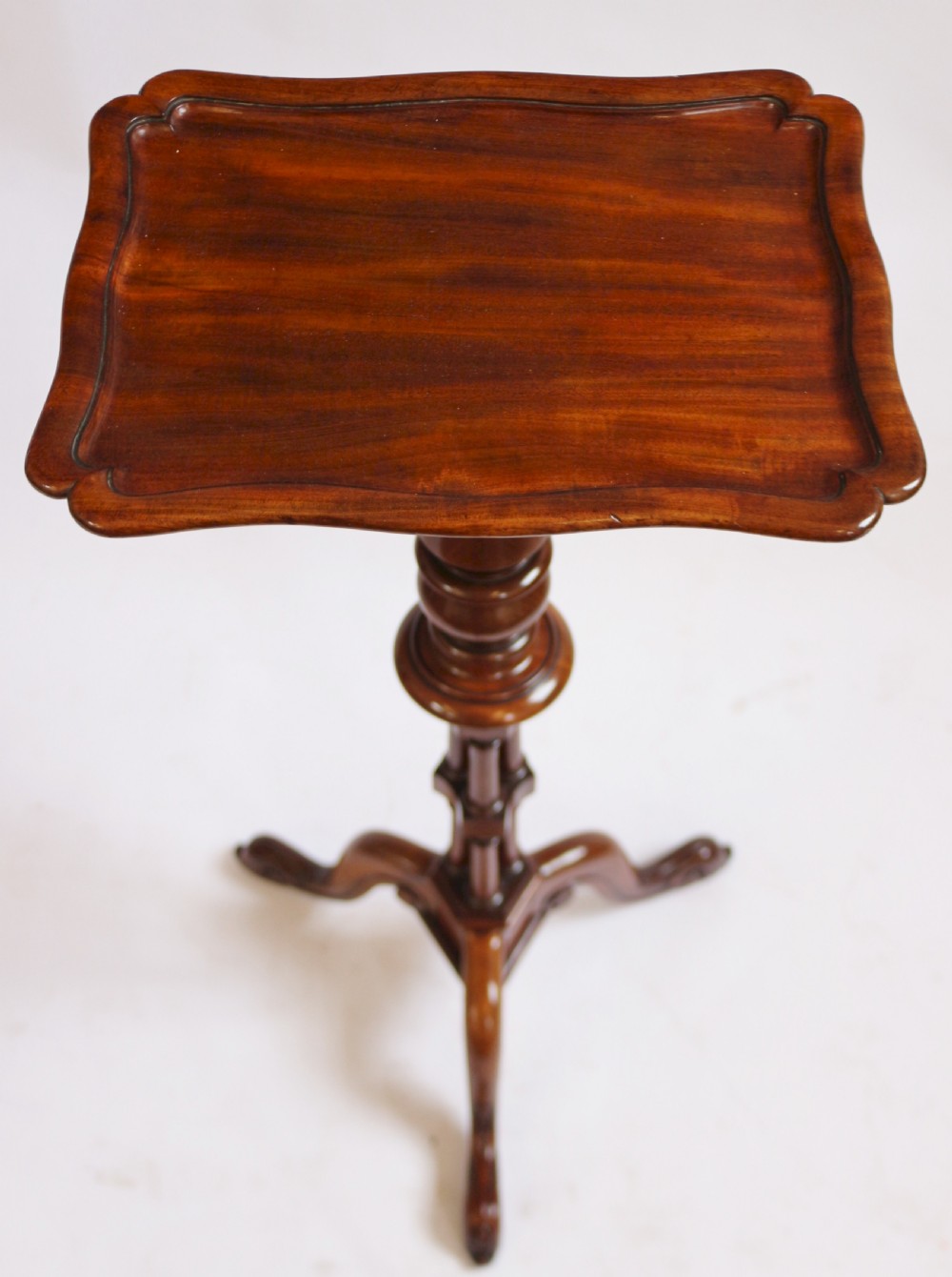 A Regency period thuyawood tripod table featuring a scalloped tray top, turned pedestal stem with clustered columns, and three scrolled feet. View IV