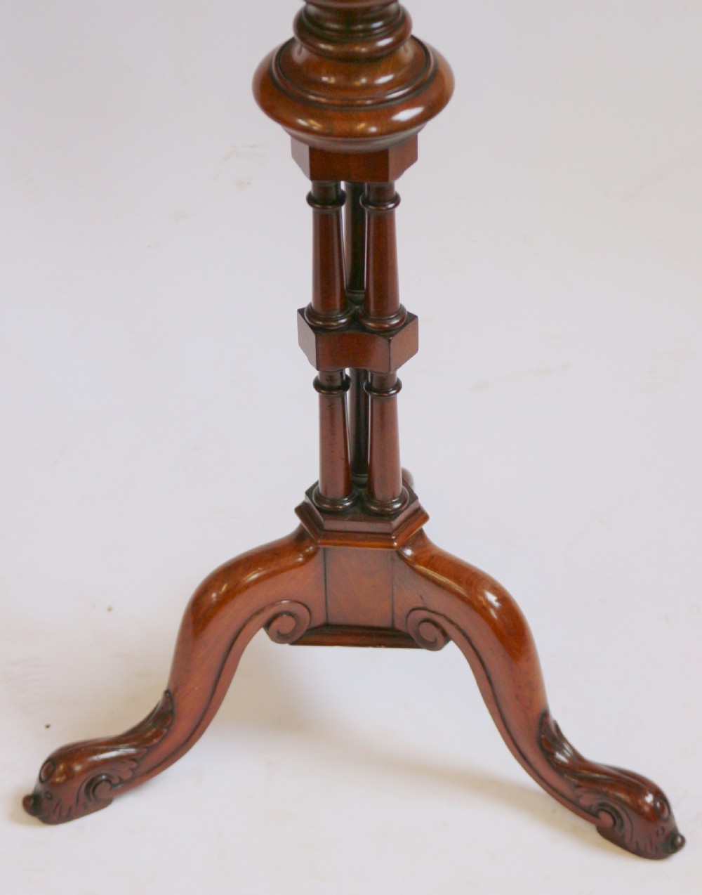 A Regency period thuyawood tripod table featuring a scalloped tray top, turned pedestal stem with clustered columns, and three scrolled feet. View VI