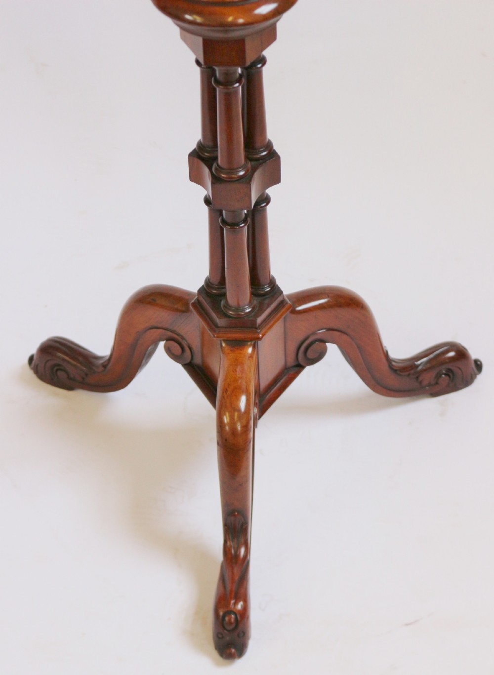A Regency period thuyawood tripod table featuring a scalloped tray top, turned pedestal stem with clustered columns, and three scrolled feet. View VII