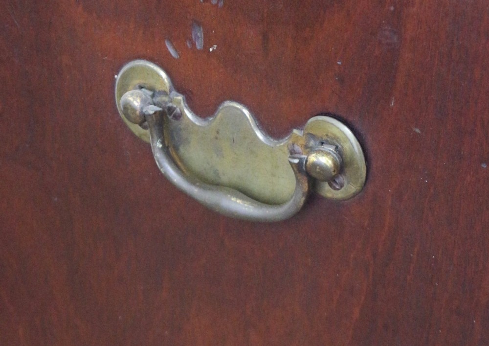 A George III mahogany two-door wardrobe featuring fielded panel doors, two base drawers with brass handles, a moulded cornice, and bracket feet. View VI