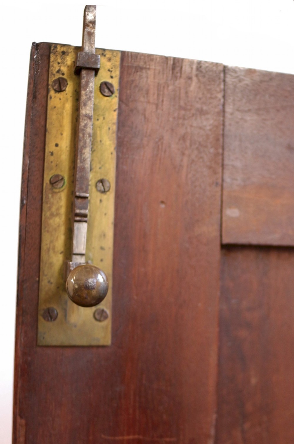 A George III mahogany two-door wardrobe featuring fielded panel doors, two base drawers with brass handles, a moulded cornice, and bracket feet. View VII