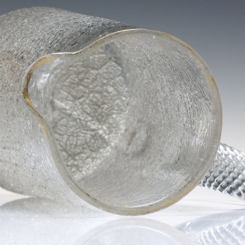 fig 2. A late 19th-century clear overshot glass water jug featuring a textured ice-like body, a twisted applied glass handle, and a subtle gilded rim.