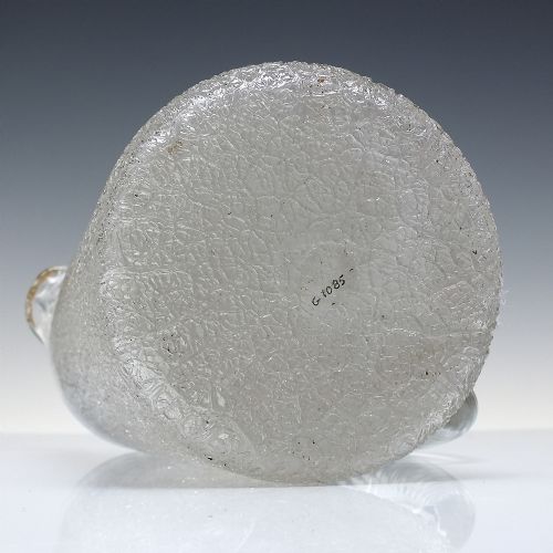 fig 3. A late 19th-century clear overshot glass water jug featuring a textured ice-like body, a twisted applied glass handle, and a subtle gilded rim.