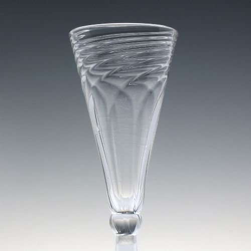 fig 2. An eighteenth-century clear glass ale goblet featuring spiral wrythen moulding on a conical bowl supported by a knopped stem and circular foot.