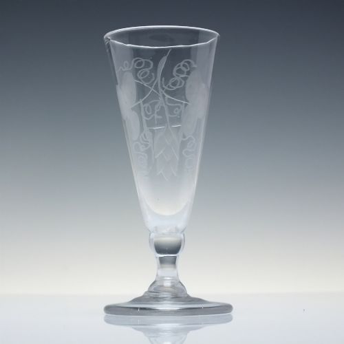fig 2. Pair of clear Georgian lead glass ale flutes featuring wheel-engraved barley and hops decoration on knopped stems.