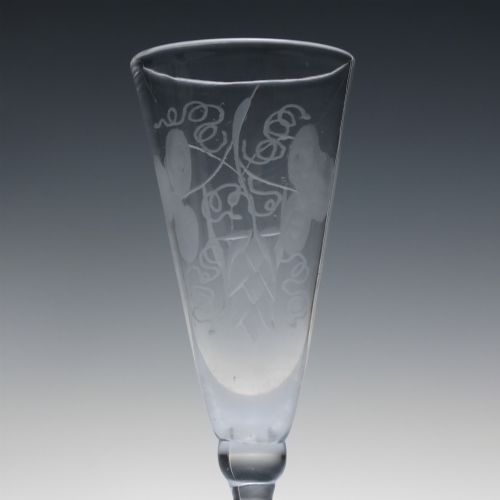 fig 3. Pair of clear Georgian lead glass ale flutes featuring wheel-engraved barley and hops decoration on knopped stems.