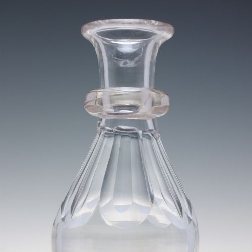 fig 1. A clear hand-blown glass Scottish whisky measure featuring a flared rim, applied neck ring, and cut shoulder flutes.
