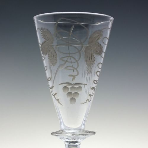 fig 4. A pair of clear hand-blown Georgian glass goblets featuring wheel-engraved motifs of hops and barley on conical bowls above knopped stems and conical bases.