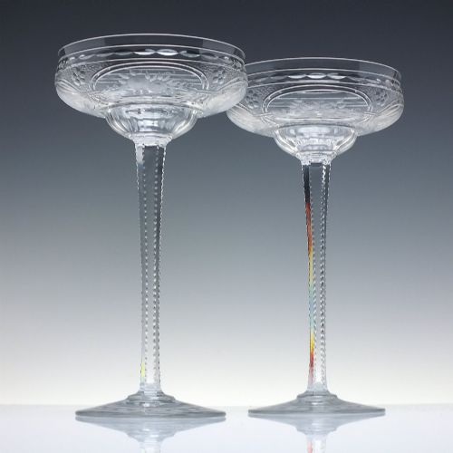 fig 1. A set of six French Art Nouveau clear lead crystal champagne coupes with tall beaded stems and etched floral motifs on shallow bowls.