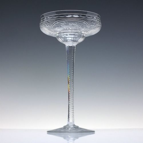 fig 2. A set of six French Art Nouveau clear lead crystal champagne coupes with tall beaded stems and etched floral motifs on shallow bowls.