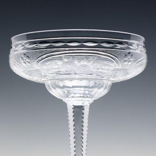 fig 3. A set of six French Art Nouveau clear lead crystal champagne coupes with tall beaded stems and etched floral motifs on shallow bowls.