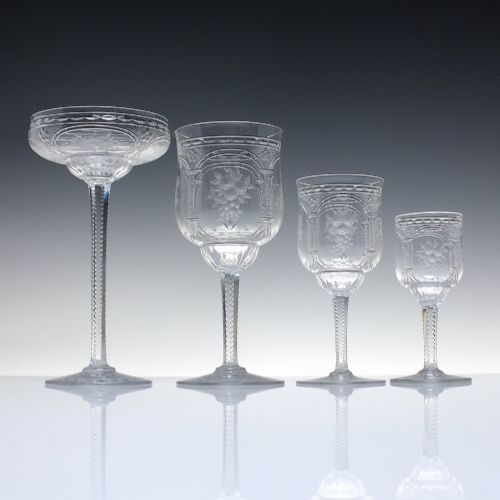 fig 5. A set of six French Art Nouveau clear lead crystal champagne coupes with tall beaded stems and etched floral motifs on shallow bowls.