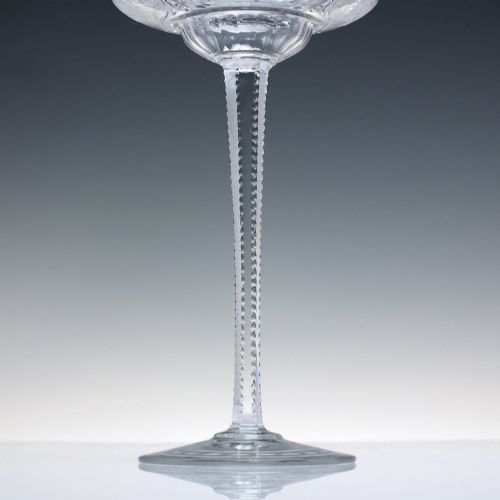 fig 8. A set of six French Art Nouveau clear lead crystal champagne coupes with tall beaded stems and etched floral motifs on shallow bowls.