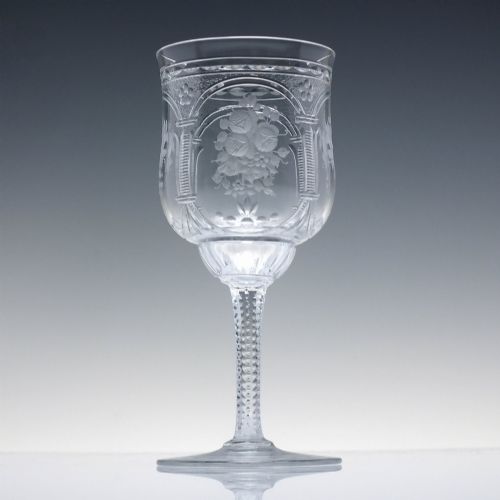 fig 2. A set of six clear lead crystal wine glasses featuring intricate acid-etched floral panels and textured facet-cut stems.