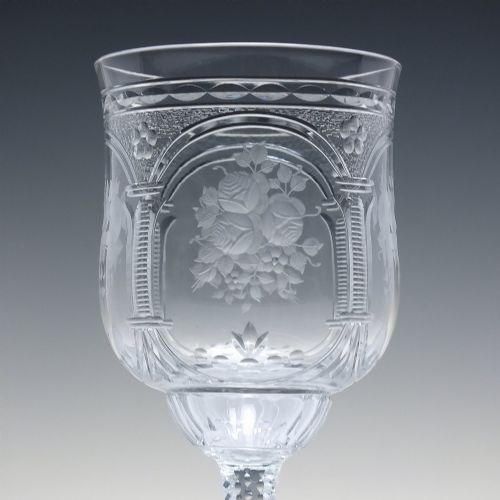 fig 3. A set of six clear lead crystal wine glasses featuring intricate acid-etched floral panels and textured facet-cut stems.