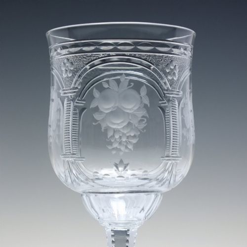 fig 4. A set of six clear lead crystal wine glasses featuring intricate acid-etched floral panels and textured facet-cut stems.