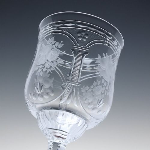 fig 7. A set of six clear lead crystal wine glasses featuring intricate acid-etched floral panels and textured facet-cut stems.