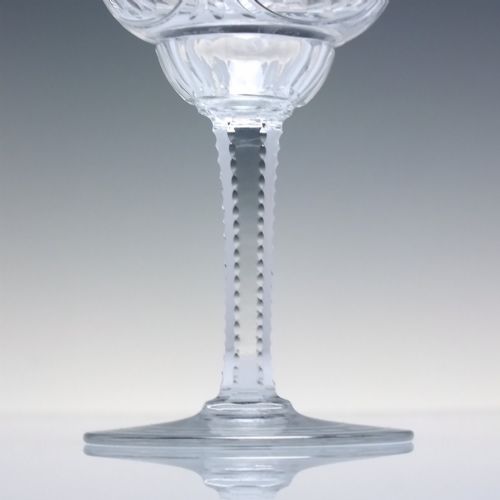 fig 8. A set of six clear lead crystal wine glasses featuring intricate acid-etched floral panels and textured facet-cut stems.