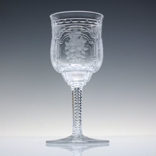 fig 2. A set of six clear lead crystal dram glasses featuring acid-etched floral panels set within archways and faceted diamond-cut stems.