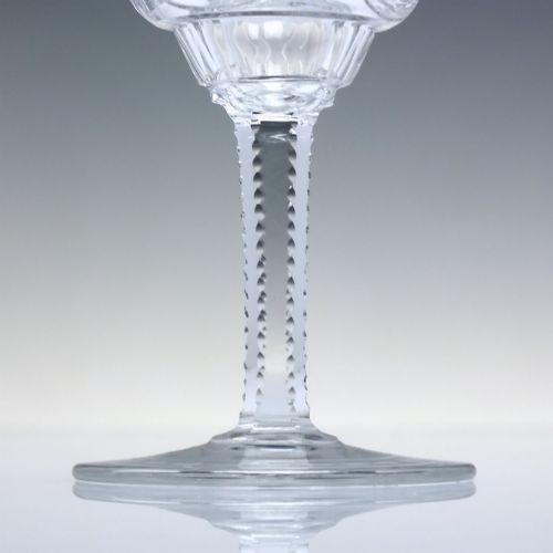 fig 3. A set of six clear lead crystal dram glasses featuring acid-etched floral panels set within archways and faceted diamond-cut stems.
