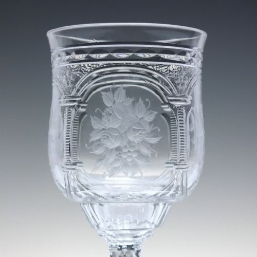 fig 4. A set of six clear lead crystal dram glasses featuring acid-etched floral panels set within archways and faceted diamond-cut stems.