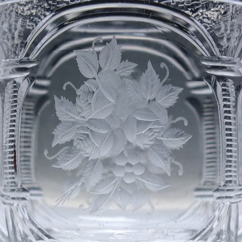 fig 5. A set of six clear lead crystal dram glasses featuring acid-etched floral panels set within archways and faceted diamond-cut stems.