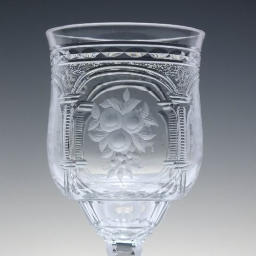 fig 6. A set of six clear lead crystal dram glasses featuring acid-etched floral panels set within archways and faceted diamond-cut stems.