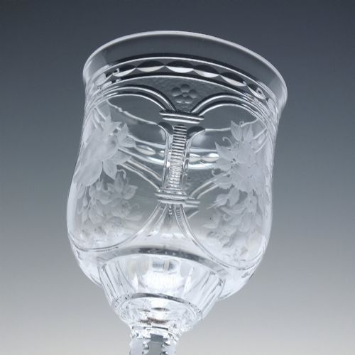 fig 8. A set of six clear lead crystal dram glasses featuring acid-etched floral panels set within archways and faceted diamond-cut stems.