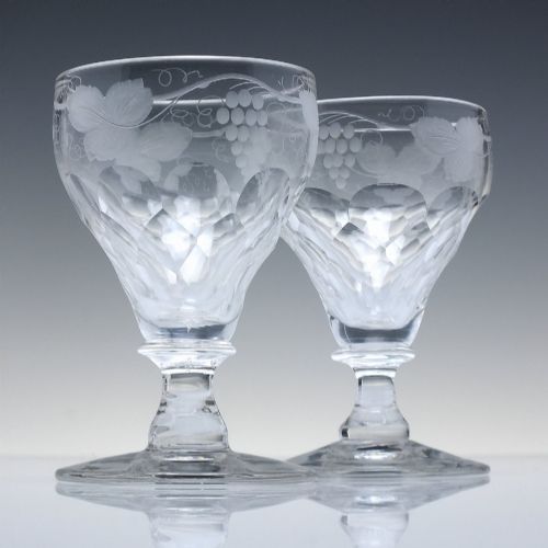 fig 1. A set of six vintage clear glass port goblets featuring wheel-engraved grapevine motifs on pan-topped bowls with cut facet details.