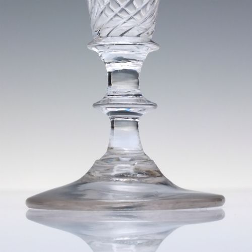 fig 2. A clear Georgian ale glass featuring half-wrythen spiral moulding on the conical bowl above a knopped stem.