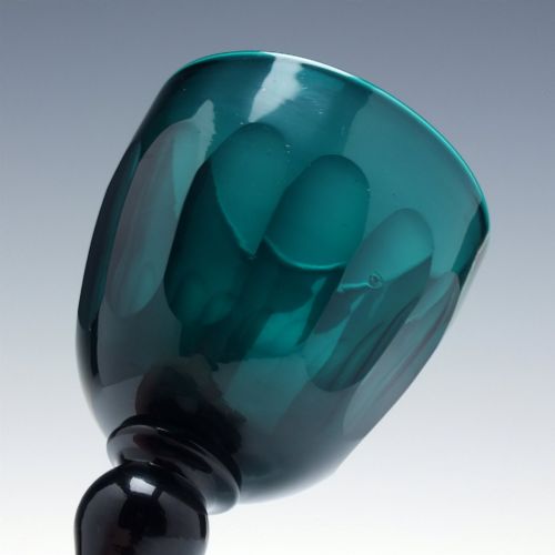 fig 2. An early 19th-century turquoise green glass wine goblet featuring a cut bowl and a knopped stem on a flat circular base.